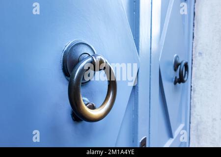 Blau strukturierte Tür mit rundem goldfarbenem Metallgriff Stockfoto