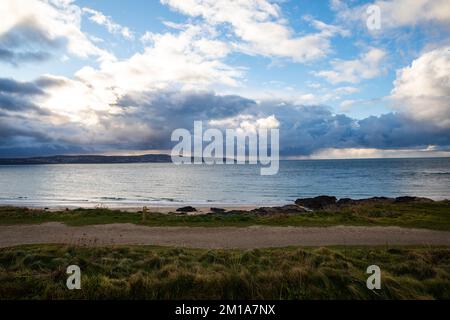 Godrevy, Cornwall, 11.. Dezember 2022, Seehunde schwammen im ruhigen Meer in Godrevy, Cornwall mit dunklem bewölktem Himmel über St Ives Bay. Die Temperatur war 6C Grad. Eine Warnung des MET-Büros bleibt bis morgen Mittag bestehen, wenn Nebel und Eis einfrieren. Kredit: Keith Larby/Alamy Live News Stockfoto