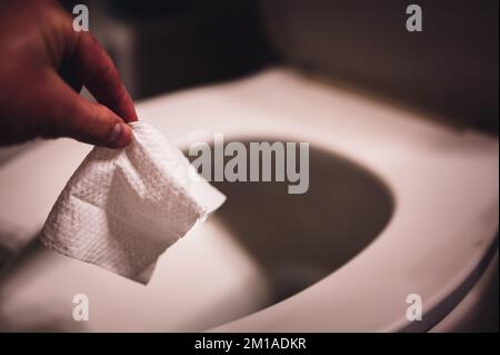 Einweg-Wischtücher werden auf der Toilette heruntergespült, wo sie Verstopfung und Probleme mit der Abwasserbehandlung verursachen können. Stockfoto