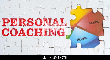 Wirtschaft und Geschäftskonzept. Auf weißen Rätseln ist eine Inschrift zu finden - PERSÖNLICHES COACHING. Finanzdiagramm im Fenster zwischen den Rätseln Stockfoto
