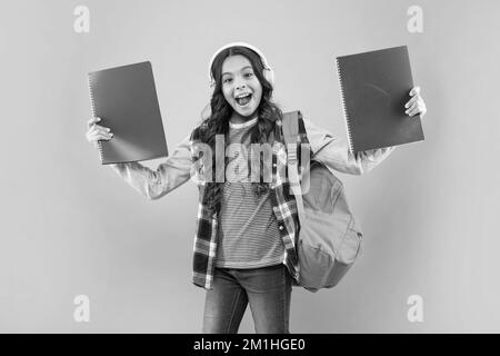 Online-Bildung. Zurück in die Schule. Überrascht Mädchen in Kopfhörer. Hören Sie Musik. Stockfoto