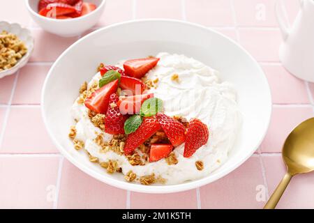 Joghurt mit Erdbeere. Weißer griechischer Joghurt mit frischen Beeren und Müsli. Gesundes Essen, Frühstück. Draufsicht Stockfoto