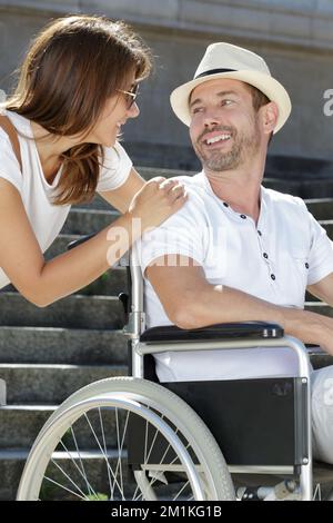 Behinderter Mann im Rollstuhl mit Freundin im Urlaub Stockfoto