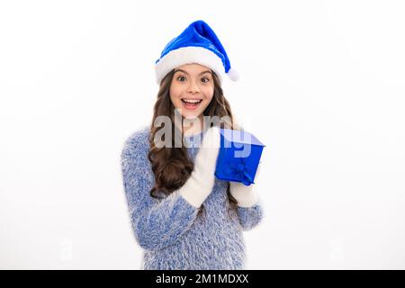 Ein weihnachtliches Teenager-Mädchen mit Geschenk, Weihnachten, Glückskonzept. Glückliches Mädchen im Winterpullover mit Geschenkbox. Isolierter stodio-Hintergrund. Stockfoto