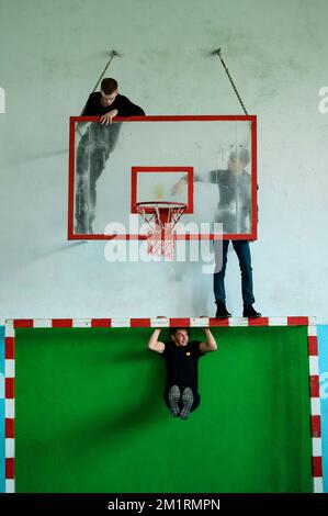 Ivano-Frankivsk, Ukraine 15. Mai 2021: Schüler werfen einen Klassenkameraden auf den Basketballkorb, Gym, Schulunterhaltung für Schüler. Stockfoto