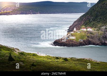 Fort Amherst Lighthouse historic site photograph taken from Signal hill with tourists overlooking a cliff near St. John's Newfoundland Canada. Stock Photo