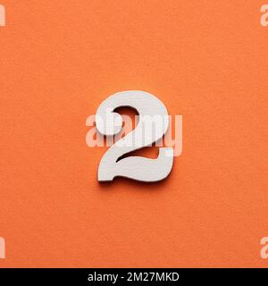 Number two - white number in wood on pink background Stockfoto