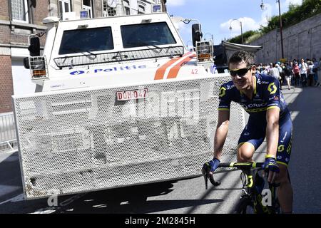 Illustration picture shows an Orica Greenedge cyclist passing heavy police vehicles at the start of the third stage of the 104th edition of the Tour de France cycling race, 212,5 km from Verviers, Belgium to Longwy, France, Monday 03 July 2017. This year's Tour de France takes place from July first to July 23rd. BELGA PHOTO DIRK WAEM  Stock Photo