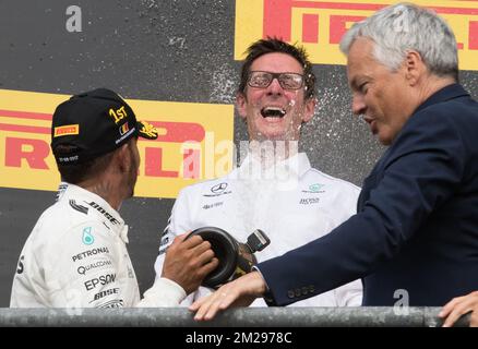 Mercedes' British driver Lewis Hamilton and Mercedes AMG Managing Director Andy Cowell celebrate on the podium with Foreign Minister Didier Reynders after winning the Spa-Francorchamps Formula One Grand Prix of Belgium race, in Spa-Francorchamps, Sunday 27 August 2017. BELGA PHOTO BENOIT DOPPAGNE Stock Photo