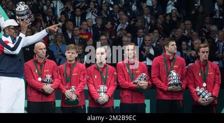 French Davis Cup captain Yannick Noah celebrates his victory as Belgian captain Johan Van Herck, Belgian David Goffin, Belgian Steve Darcis, Belgian Ruben Bemelmans, Belgian Joris De Loore and Belgian Arthur De Greef look dejected after a tennis game between Belgian Steve Darcis and French Lucas Pouille, the fifth and last game of the Davis Cup World Group final between France and Belgium, Sunday 26 November 2017, in Villeneuve-d'Ascq. France wins the Davis Cup World Group final. BELGA PHOTO BENOIT DOPPAGNE Stock Photo