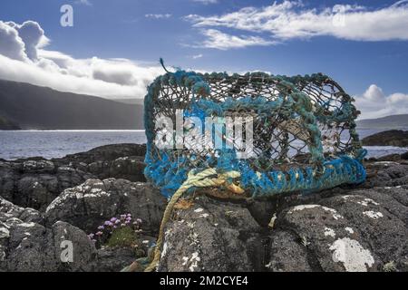 Lobster trap / lobster creel, made of non-degradable plastic and nylon, washed ashore on rocky beach in Scotland, UK | Casier à homards / nasse jeté sur la plage en Ecosse, Royaume-Uni 02/06/2017 Stock Photo