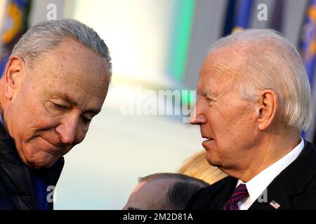 United States President Joe Biden talks to US Senate Majority Leader Chuck Schumer (Democrat of New York)after signing the Respect for Marriage Acton during a ceremony on the South Lawn of the White House in Washington, DC on December 13, 2022.Credit: Yuri Gripas/Pool via CNP /MediaPunch Stock Photo