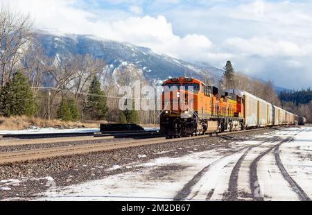 A BNSF diesel electric train locomotive coming through the rail yard in the town of Troy, Montana. Stock Photo