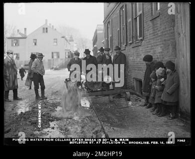 Distribution Department, Low Service Pipe Lines, pumping water from cellars after break in 30-inch main, Boylston Street at Boylston Place; Cameron Street, Brookline, Mass., Feb. 14, 1917 , waterworks, pipes conduits, construction sites Stock Photo