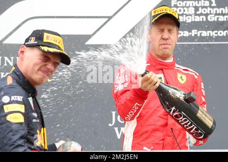 Third place Red Bull's Dutch driver Max Verstappen and Winner Ferrari's German driver Sebastian Vettel celebrate on the podium with champagne after the Spa-Francorchamps Formula One Grand Prix of Belgium race, in Spa-Francorchamps, Sunday 26 August 2018. BELGA PHOTO BENOIT DOPPAGNE  Stock Photo