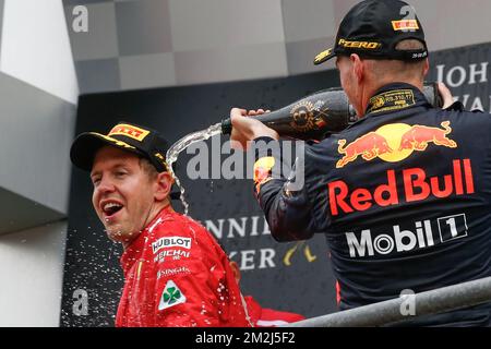 Winner Ferrari's German driver Sebastian Vettel and Third place Red Bull's Dutch driver Max Verstappen celebrate on the podium with champagne after the Spa-Francorchamps Formula One Grand Prix of Belgium race, in Spa-Francorchamps, Sunday 26 August 2018. BELGA PHOTO BRUNO FAHY Stock Photo