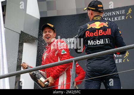 Winner Ferrari's German driver Sebastian Vettel and Third place Red Bull's Dutch driver Max Verstappen celebrate on the podium with champagne after the Spa-Francorchamps Formula One Grand Prix of Belgium race, in Spa-Francorchamps, Sunday 26 August 2018. BELGA PHOTO BRUNO FAHY Stock Photo