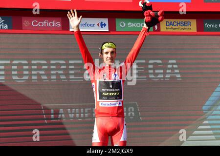 Britain's Simon Yates of Mitchelton - Scott celebrates on the podium in the red jersey for leader in the general ranking, after the 16th stage of the 'Vuelta a Espana', Tour of Spain cycling race, a 32km individual time trial from Santillana del Mar to Torrelavega, Spain, Tuesday 11 September 2018. BELGA PHOTO YUZURU SUNADA FRANCE OUT Stock Photo