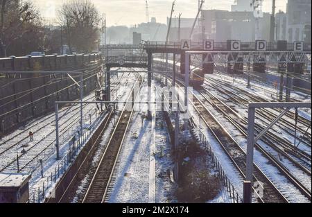 London, UK. 14th December 2022. A train passes along snow and ice-covered tracks in Camden as the rail strikes continue across the UK amid freezing temperatures. Credit: Vuk Valcic/Alamy Live News Stock Photo