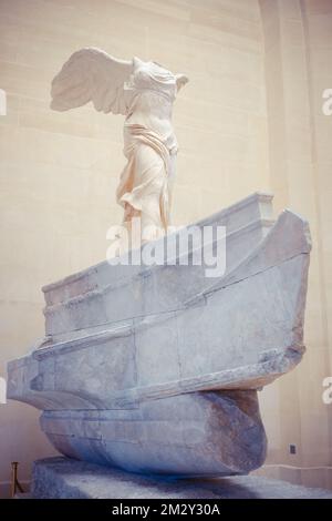 A vertical shot of the Winged Victory of Samothrace. Louvre Museum, Paris, France. Stock Photo