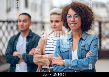 Three multiethnic young people on the veranda Stockfoto