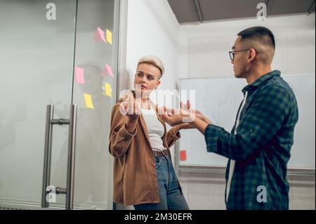 Corporate workers engaged in the discussion of a business project Stock Photo