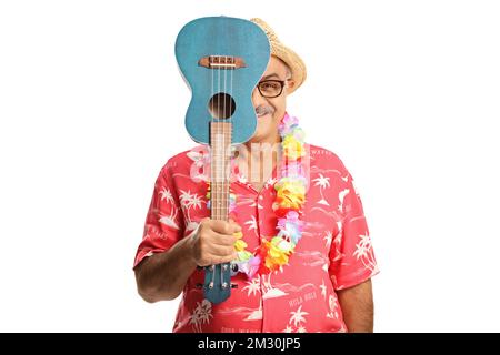 Smiling man hiding behind ukulele instrument isolated on white background Stock Photo