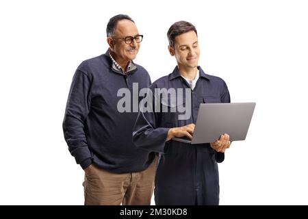 Male worker in a uniform showing a laptop computer to a mature man isolated on white background Stock Photo