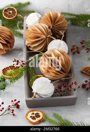 Christmas Honeycomb ball made from white und brown coffee filter. Handmade Christmas tree decoration. Seasonal activity with kids. Stock Photo