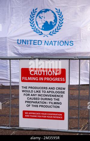 Warnschild beim Filmen für Serie 6 von Netflix The Crown vor Ort in Southend on Sea, Essex, Großbritannien. Kosovo-Filmset mit UN-Zelt Stockfoto