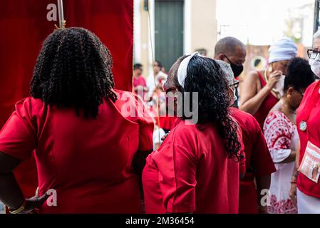 Salvador, Bahia, Brasilien - 04. Dezember 2022: Anhänger von Santa Barbara, die während der Messe im Largo do Pelourinho in der Stadt Salvador rot gekleidet waren. Stockfoto