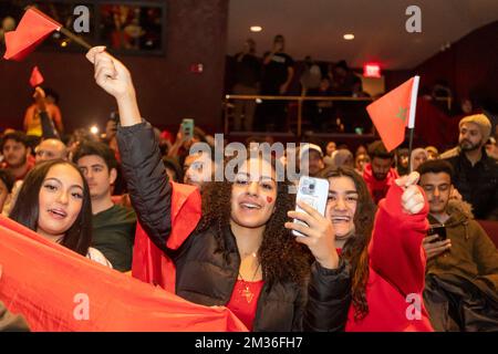 Dearborn, Michigan, USA. 14.. Dezember 2022. Arabisch-Amerikaner packten ein Theater, um Marokko bei seinem Spiel gegen Frankreich im Halbfinale der FIFA-Weltmeisterschaft anzufeuern. Die Watch Party, in der Dearborns erster arabisch-amerikanischer Bürgermeister, Abdullah Hammoud, Gastgeber war, zog eine große Menge an. Marokko ist die erste afrikanische oder arabische Nation, die es jemals zum Halbfinale der Weltmeisterschaft geschafft hat. Kredit: Jim West/Alamy Live News Stockfoto