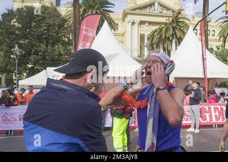 A 73 year old man seen celebrating with his grandchild during the Generali Marathon 2022 in Malaga. Stock Photo