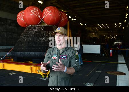 Pacific Ocean. 11th Dec, 2022. Lt. Col. Richard Bolton, 1st Air Force Det.3 commander, conducts a media interview aboard the USS Portland following the successful recover of the Orion capsule. Sailors aboard amphibious transport dock USS Portland (LPD 27) use a line load attenuating mechanism assembly to pull the NASA Artemis I Orion spacecraft into the well deck. (Credit Image: © U.S. Navy/ZUMA Press Wire Service) Stock Photo