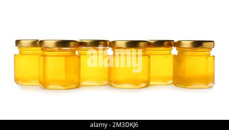 Frischer Honig in Gläsern auf weißem Hintergrund Stockfoto