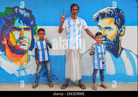 Nicht exklusiv: 14. Dezember 2022 in Sylhet, Bangladesch: Argentinische Fans feiern, posieren vor einem Wandbild seines Helden Lionel Messi, gewinnen Kroatien i. Stockfoto