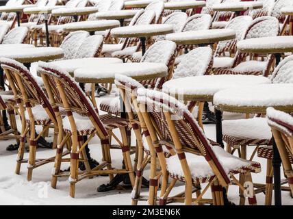 München, Deutschland. 15.. Dezember 2022. Schneebedeckte Stühle und Tische stehen vor einem Café in der Innenstadt. Kredit: Peter Kneffel/dpa/Alamy Live News Stockfoto