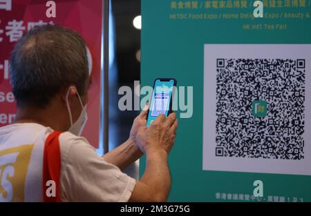 People scan the QR code of the exhibition hall and are to show their proof of vaccination status by scanning the QR code in the Leave Home Safe app as the vaccine pass is required for entry of Hong Kong Food Expo at Hong Kong Convention and Exhibition Centre, Wan Chai. 12AUG22.  SCMP/ Dickson Lee Stock Photo