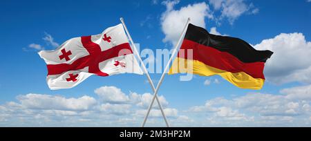 Zwei überkreuzte Flaggen Bundesrepublik Deutschland und Georgien winken im Wind am bewölkten Himmel. Beziehungskonzept, Dialog, Reisen zwischen zwei Zählern Stockfoto