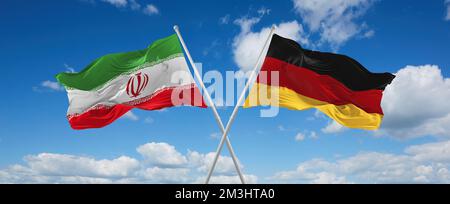 Zwei gekreuzte Flaggen Bundesrepublik Deutschland und Iran, die im Wind am bewölkten Himmel winken. Beziehungskonzept, Dialog, Reisen zwischen zwei Ländern Stockfoto
