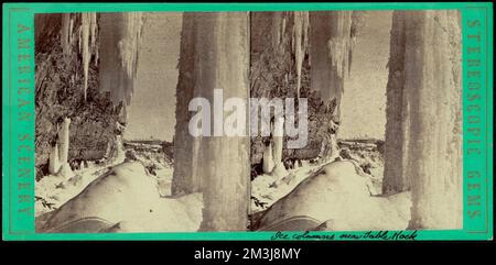 Niagara im Winter. Eissäulen unter dem Ufer, in der Nähe von Table Rock, Clifton House in der Ferne, Schnee, Eiszapfen, Felsformationen Stockfoto