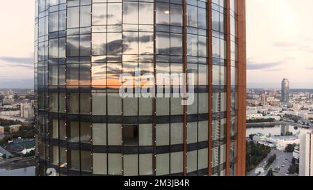 Fenster des Bürogebäudes und Luftblick auf den Wolkenkratzer. Aktie-Aufnahmen. Gebäude mit vielen Firmenbüros, Immobilien für Miete und kommerzielle Nutzung Stockfoto