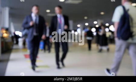 Verschwommene Menschenmenge, die in einem Einkaufs- oder Business-Center vorbeigeht. Medien. Viele Unschärfer im Einkaufszentrum Stockfoto