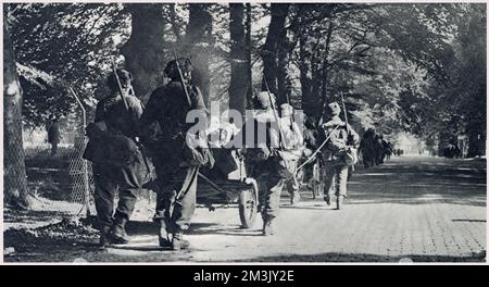 Soldaten der British First Airborne Division marschierten mit ihren Waffen und Ausrüstung nach der Landung außerhalb der Stadt am 1944. September nach Arnheim. Am 17. September 1944 wurde die Operation "Market Garden" in die Tat umgesetzt; ein mutiger Plan, den Feldmarschall Montgomery entworfen hatte, um tausende von Luftstreitkräften nach Holland abzusetzen, um eine Invasionsroute nach Deutschland zu erobern. Die britische First Airborne, die amerikanische 81.- und 101.-Division nahmen an dem Plan Teil, der letztendlich erfolglos war. Stockfoto