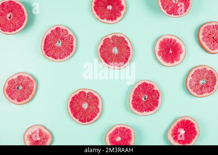 Gemusterte Grapefruit-Zitrusscheiben mit pastellfarbenem Hintergrund. Auflösung und hochwertige Fotos Stockfoto