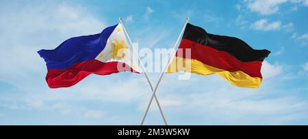 Zwei überkreuzte Flaggen Bundesrepublik Deutschland und Philippinen winken im Wind am bewölkten Himmel. Beziehungskonzept, Dialog, Reisen zwischen zwei CO Stockfoto