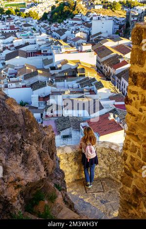 Eine Frau, die an das wunderschöne Dorf der weißen Häuser in Andalusien, Olvera, Cadiz denkt. Stockfoto
