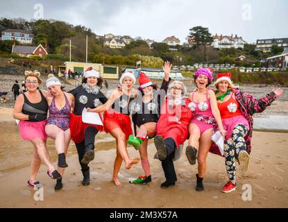 Fondssammler werden vor dem Aufbruch in das eisige kalte Wasser in Langland Bay, Swansea, während der alljährlichen Santa Surf Veranstaltung, die jedes Jahr am Gower Beach stattfindet, um Geld für Surfer gegen die Kanalisation zu sammeln und den Surfern vor Ort dabei zu helfen, in Weihnachtsstimmung zu kommen, fotografiert. Stockfoto