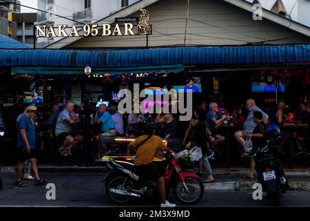 Touristen werden in einer Bar an der Hauptstraße in Pattaya gesehen. Das tägliche Leben in Pattaya, Provinz Chonburi, Thailand am 17. Dezember 2022. Das bei Touristen sehr bekannte Gebiet ist einer der Schwerpunktbereiche, die die thailändische Tourismusbehörde (Tat) gefördert hat, um mehr ausländische Touristen in das Land zu locken und damit seine tourismusabhängige Wirtschaft zu retten. Stockfoto