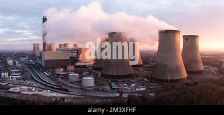 Blick aus der Vogelperspektive auf das Drax Kohlekraftwerk in North Yorkshire mit Rauchschornsteinen und Kühltürmen mit Schadstoffemissionen bei Sonnenuntergang Stockfoto